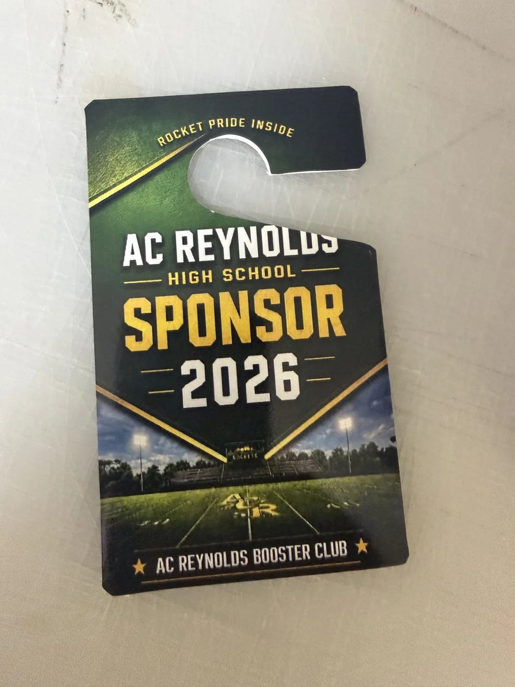 Custom-cut AC Reynolds High School sponsor pass