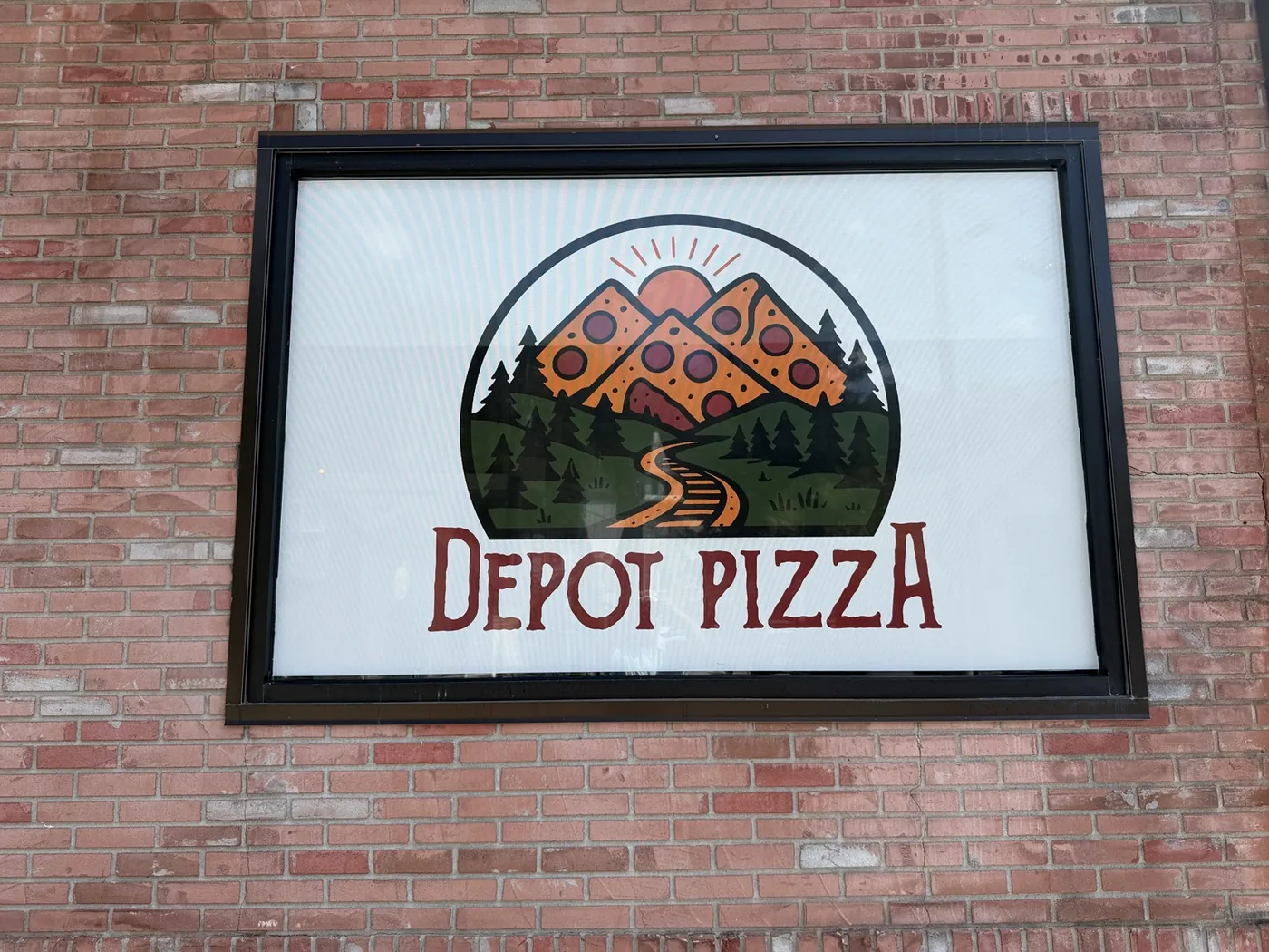 Full-color Depot Pizza graphic installed in a storefront window