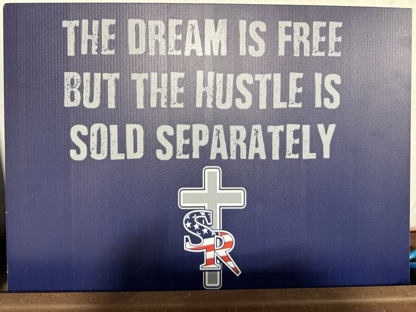 Navy motivational school sign with white lettering and patriotic logo