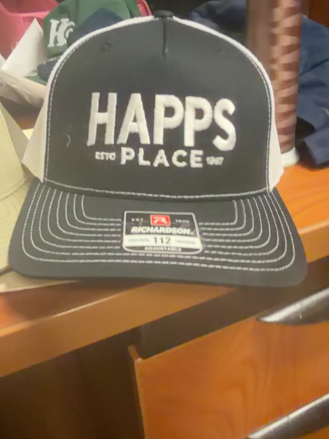 Black and white cap embroidered with HAPPS PLACE