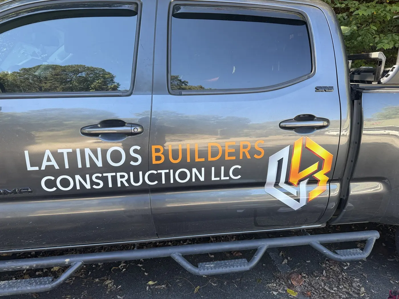 Latinos Builders Construction LLC lettering and logo on a pickup truck