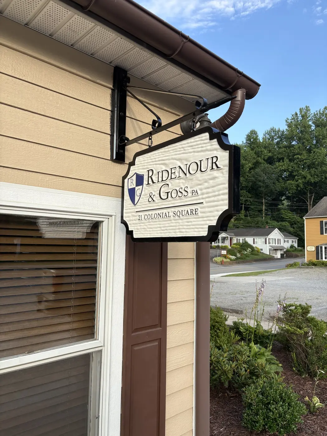 Wood carved hanging sign for Ridenour and Goss PA